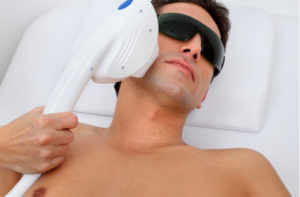 man in laser safety goggles in spa salon